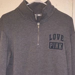 woman’s pink quarter zip up